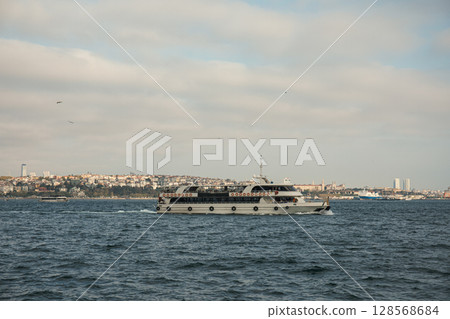 Boat sailing across the water with Istanbul skyline in view 128568684