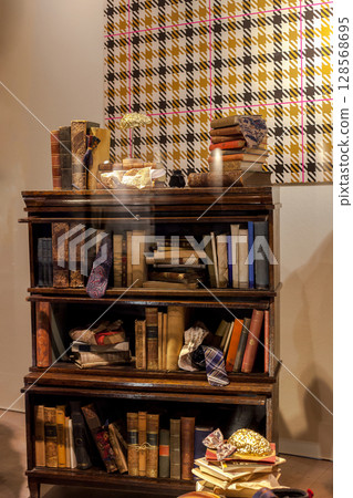 Low wood bookcase. Wooden shelves with old books 128568695