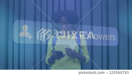 Image of social network notification over african american using smartphone in street Image of social network notification over african american using smartphone in street 128568783