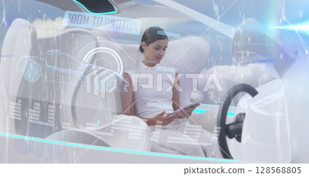 Image of data processing over woman using tablet in self drive car Image of data processing over woman using tablet in self drive car 128568805