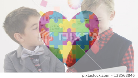 Image of autism awareness month colourful puzzle pieces forming heart over schoolboys Image of autism awareness month colourful puzzle pieces forming heart over schoolboys 128568846