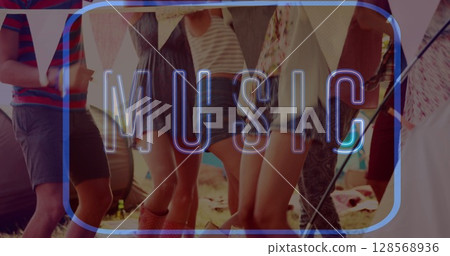 Image of neon music text in blue over friends dancing at beach party 128568936