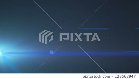 Image of blue spotlight with lens flare on dark background 128568947