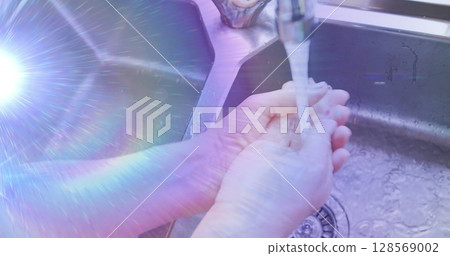 Image of light moving over midsection of senior woman washing hands in kitchen sink Image of light moving over midsection of senior woman washing hands in kitchen sink 128569002