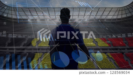 Image of graphs and data processing over rugby player holding ball at sports stadium Image of graphs and data processing over rugby player holding ball at sports stadium 128569034