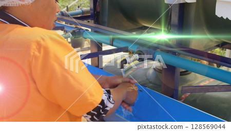 Image of red light spots over african american woman washing hands outdoors at standpipe 128569044