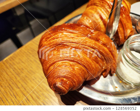 Dining table with croissants 128569352