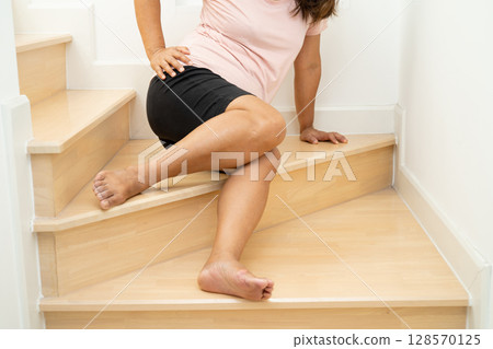 Asian lady fall down the stairs and pain at knee because slippery surfaces. 128570125