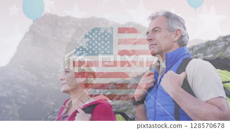 Image of american flag over senior caucasian couple hiking in mountains 128570678