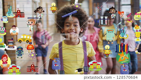 Image of school icons floating over happy schoolboy at school 128570684