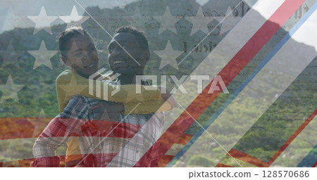 Image of american flag over smiling diverse couple embracing in mountains Image of american flag over smiling diverse couple embracing in mountains 128570686