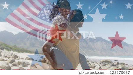 Image of american flag over smiling diverse couple carrying in mountains 128570687