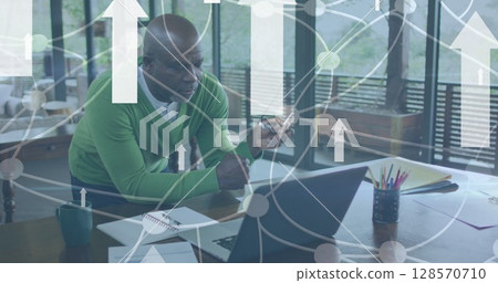 Image of white arrows and connections over businessman using laptop Image of white arrows and connections over businessman using laptop 128570710