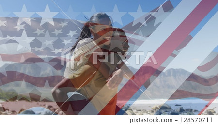 Image of american flag over smiling diverse couple carrying in mountains Image of american flag over smiling diverse couple carrying in mountains 128570711
