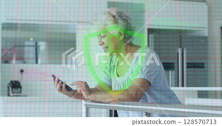 Image of biometric fingerprint padlock over senior woman using smartphone Image of biometric fingerprint padlock over senior woman using smartphone 128570713