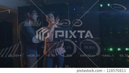 Image of data processing, diverse male and female it engineers with laptop by computer servers Image of data processing, diverse male and female it engineers with laptop by computer servers 128570811