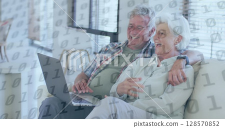 Image of binary coding over senior caucasian couple using laptop 128570852