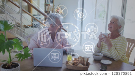 Image of network of connections over senior caucasian couple using laptop Image of network of connections over senior caucasian couple using laptop 128570891