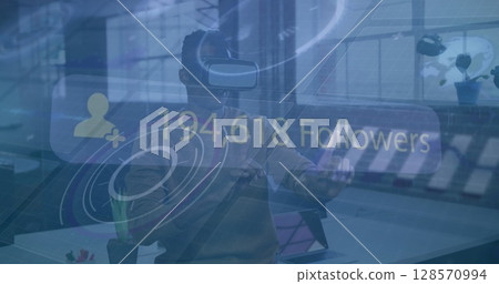 Image of social media data over businessman wearing vr headset in modern office Image of social media data over businessman wearing vr headset in modern office 128570994
