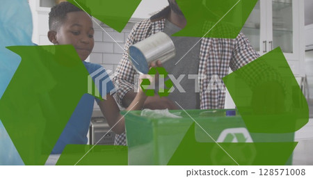 Image of green recycling sign over african american dad and son recycling 128571008