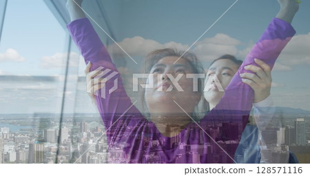 Image of asian female physiotherapist treating asian woman at home over cityscape Image of asian female physiotherapist treating asian woman at home over cityscape 128571116
