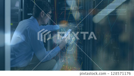 Image of flickering road lights over asian it technician with smartphone by computer server Image of flickering road lights over asian it technician with smartphone by computer server 128571176
