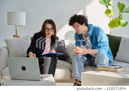 Psychological session therapy, young guy and therapist looking at computer together 128571954
