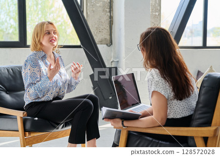 Mental therapy session, middle aged woman patient talking to professional psychologist 128572028