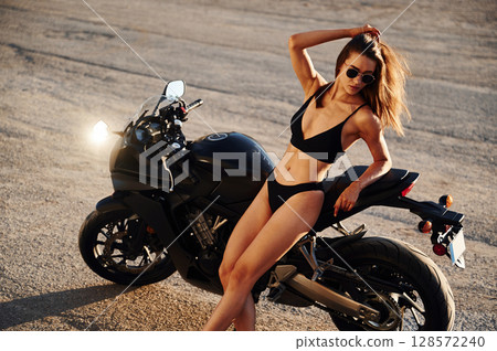 Hot woman in underwear is with motorcycle outdoors Hot woman in underwear is with motorcycle outdoors 128572240