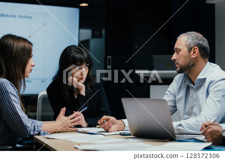 Business executives discussing startup investment losses in boardroom meeting 128572306