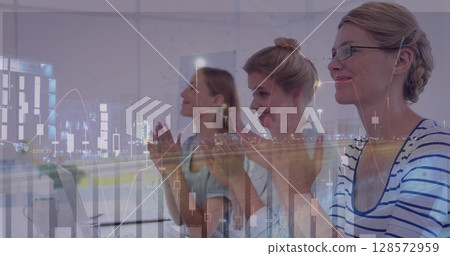 Image of statistics and financial data processing over businesswomen clapping in meeting 128572959