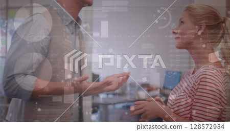 Image of diverse data and clock over caucasian female and male colleagues talking in office 128572984