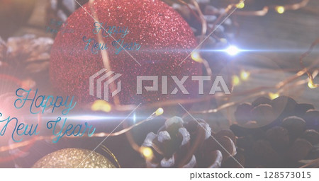 Image of happy new year text over christmas decorations 128573015