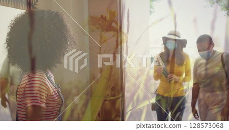 Image of diverse family with face masks greeting with elbows over grass 128573068
