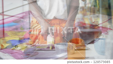 Image of african american man painting over painting 128573085