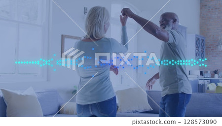 Image of happy diverse couple dancing over light spots moving 128573090