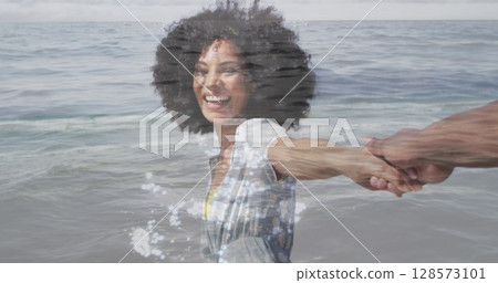 Image of happy african american couple walking at beach over sea 128573101