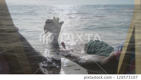 Image of senior african american couple on beach over sea 128573107