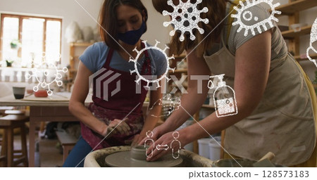 Image of virus icons over caucasian women with face masks forming pottery Image of virus icons over caucasian women with face masks forming pottery 128573183