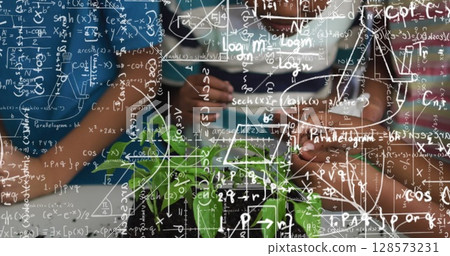 Image of mathematical equations over schoolchildren during class 128573231