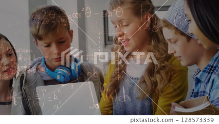 Image of mathematical equations over school children using laptop in classroom 128573339