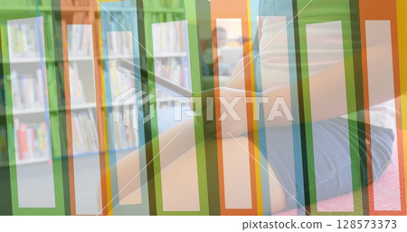 Image of books moving over child using tablet in library 128573373