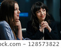 Senior female partner mentoring junior manager celebrating success and workplace solidarity 128573822