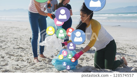 Image of falling people icons over diverse female group picking up rubbish from beach Image of falling people icons over diverse female group picking up rubbish from beach 128574557