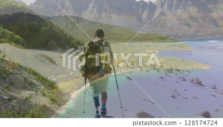 Composite image of a beach against african american man hiking on the mountains Composite image of a beach against african american man hiking on the mountains 128574724