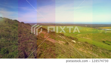 Composite image of transparent striped overlay against aerial view of grassland Composite image of transparent striped overlay against aerial view of grassland 128574730