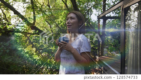 Image of rainbow fog over happy young asian woman 128574733
