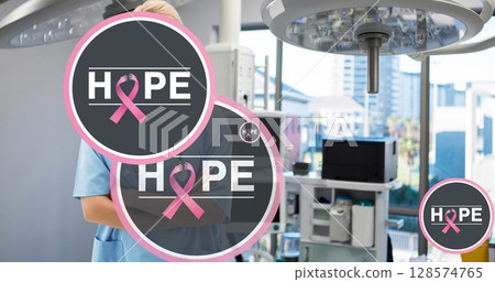 Image of hope and breast cancer awareness ribbons over caucasian female doctor 128574765
