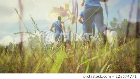 Image of group of caucasian male and female runners over grass Image of group of caucasian male and female runners over grass 128574771