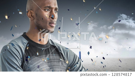 Image of confetti over african american male rugby player with ball at stadium 128574817